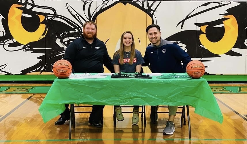 Sydnee and coaches at signing.